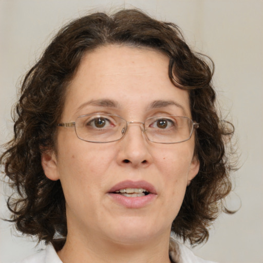 Joyful white adult female with medium  brown hair and green eyes