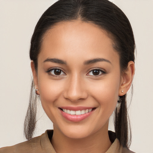 Joyful white young-adult female with long  brown hair and brown eyes