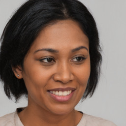 Joyful latino young-adult female with medium  brown hair and brown eyes