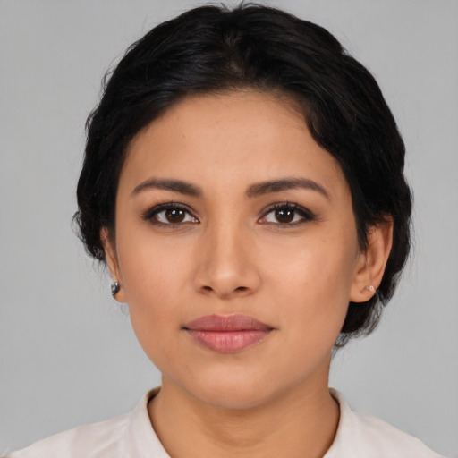 Joyful latino young-adult female with medium  black hair and brown eyes