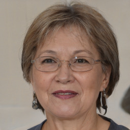 Joyful white middle-aged female with medium  brown hair and brown eyes