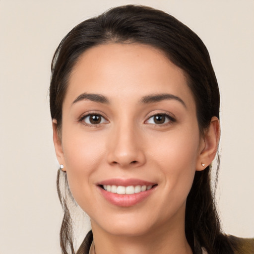 Joyful white young-adult female with long  brown hair and brown eyes