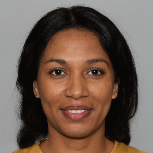 Joyful black young-adult female with medium  black hair and brown eyes