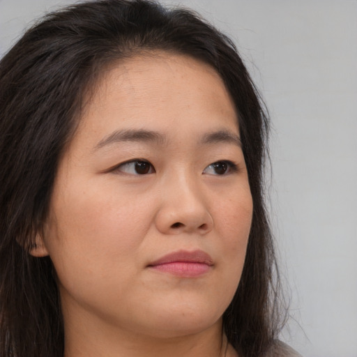 Joyful asian young-adult female with long  brown hair and brown eyes