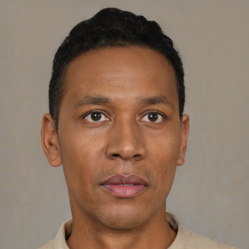 Neutral latino adult male with short  black hair and brown eyes