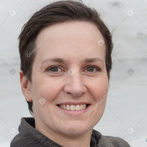 Joyful white adult female with short  brown hair and grey eyes