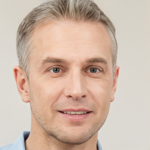 Joyful white adult male with short  brown hair and grey eyes