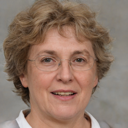 Joyful white middle-aged female with medium  brown hair and blue eyes