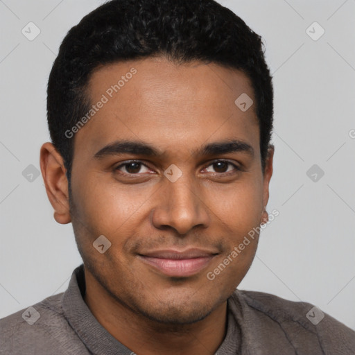 Joyful black young-adult male with short  black hair and brown eyes