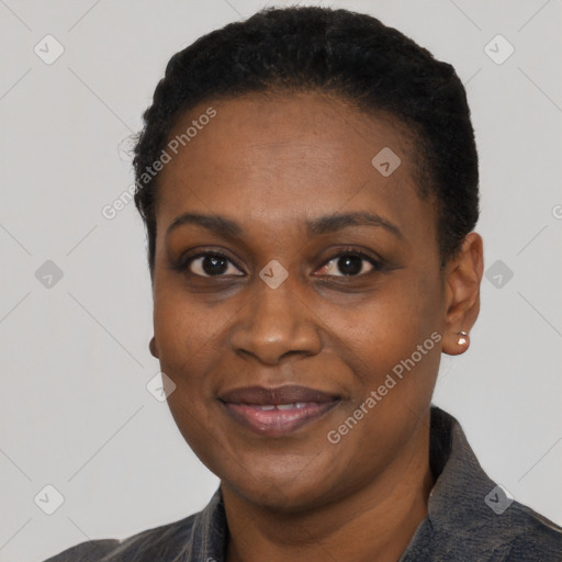 Joyful black adult female with short  black hair and brown eyes