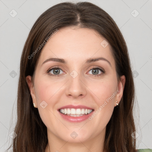 Joyful white young-adult female with long  brown hair and grey eyes