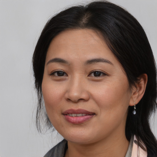 Joyful asian young-adult female with medium  brown hair and brown eyes