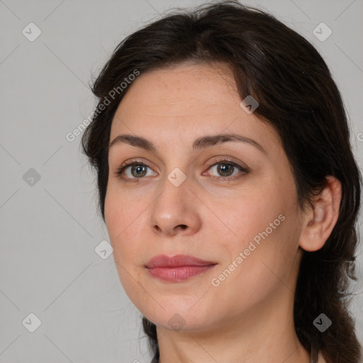 Joyful white adult female with medium  brown hair and brown eyes