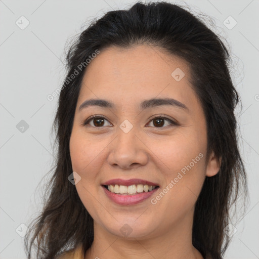 Joyful latino young-adult female with medium  brown hair and brown eyes