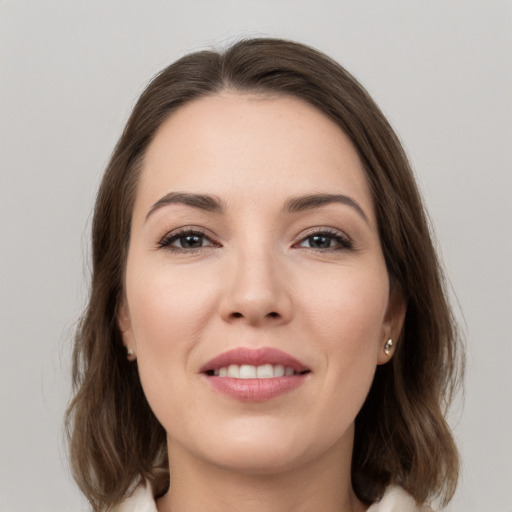 Joyful white young-adult female with medium  brown hair and brown eyes