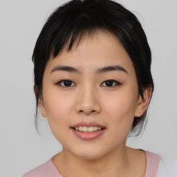 Joyful asian young-adult female with medium  black hair and brown eyes