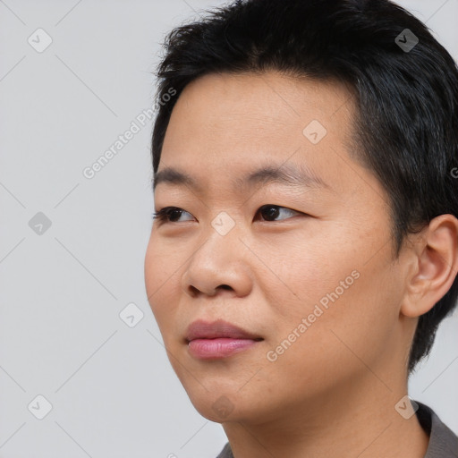 Joyful asian young-adult male with short  black hair and brown eyes