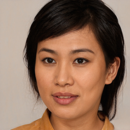 Joyful asian young-adult female with medium  brown hair and brown eyes
