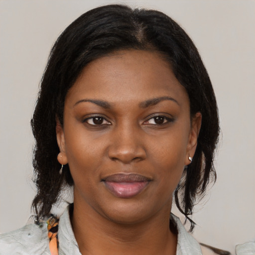 Joyful black young-adult female with medium  black hair and brown eyes