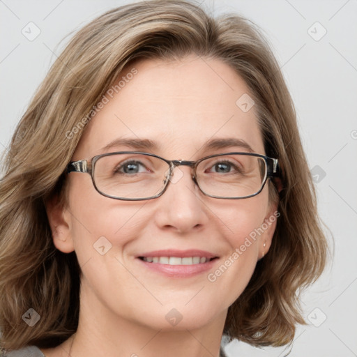 Joyful white adult female with medium  brown hair and blue eyes