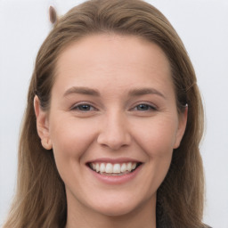 Joyful white young-adult female with long  brown hair and grey eyes