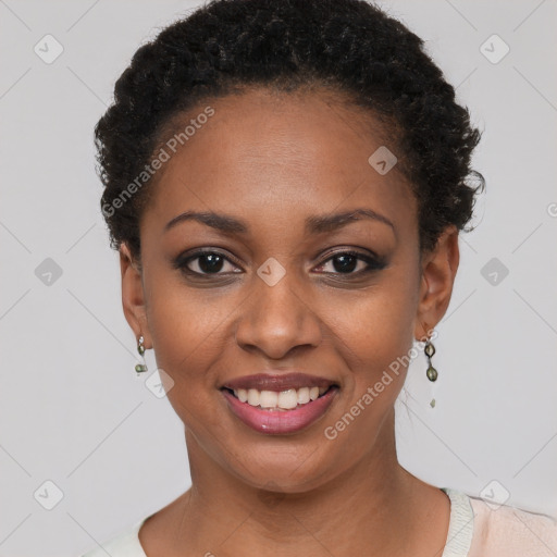 Joyful black young-adult female with short  black hair and brown eyes