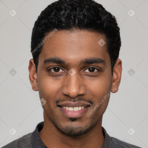 Joyful black young-adult male with short  black hair and brown eyes