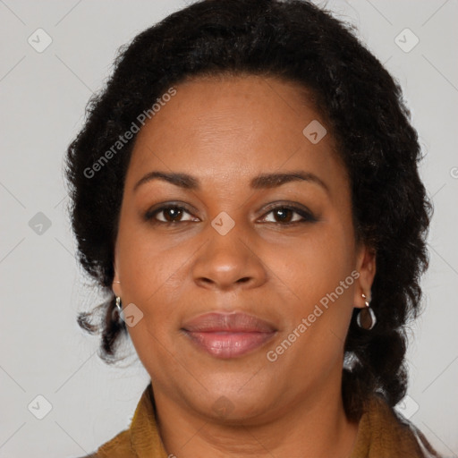 Joyful black adult female with long  brown hair and brown eyes