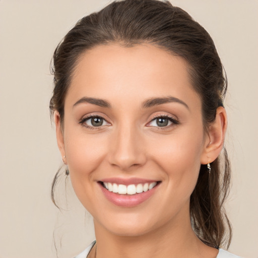 Joyful white young-adult female with medium  brown hair and brown eyes