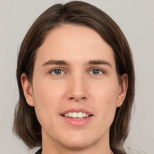 Joyful white young-adult male with medium  brown hair and brown eyes