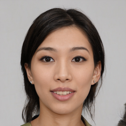 Joyful asian young-adult female with medium  black hair and brown eyes