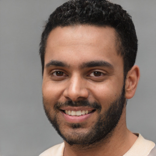 Joyful white young-adult male with short  black hair and brown eyes