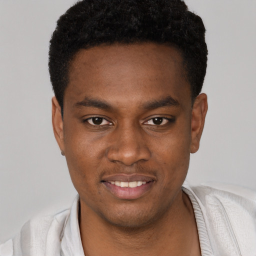 Joyful black young-adult male with short  black hair and brown eyes