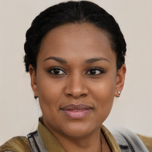 Joyful black young-adult female with short  black hair and brown eyes