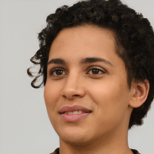 Joyful latino young-adult female with short  black hair and brown eyes