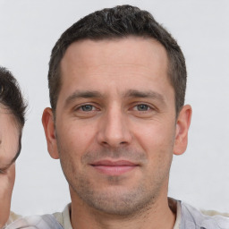 Joyful white adult male with short  brown hair and brown eyes