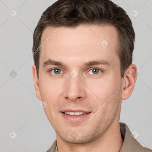 Joyful white young-adult male with short  brown hair and grey eyes