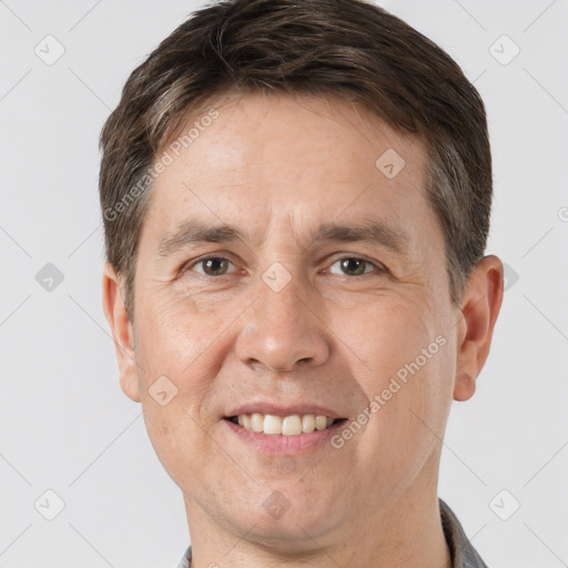 Joyful white adult male with short  brown hair and brown eyes