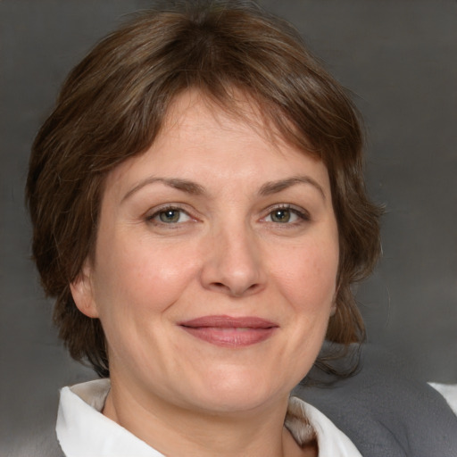 Joyful white adult female with medium  brown hair and brown eyes