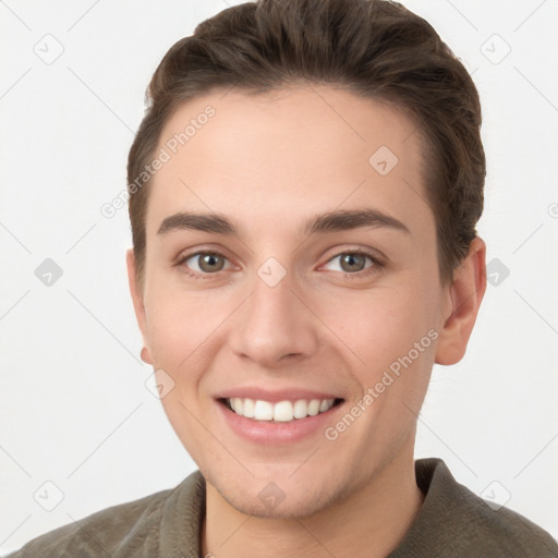 Joyful white young-adult female with short  brown hair and grey eyes