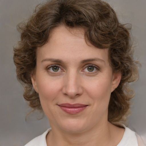 Joyful white young-adult female with medium  brown hair and green eyes