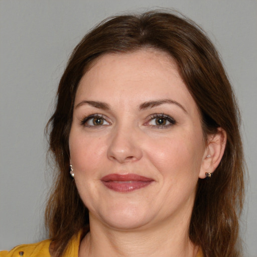 Joyful white adult female with medium  brown hair and brown eyes