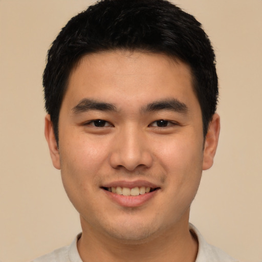 Joyful asian young-adult male with short  black hair and brown eyes