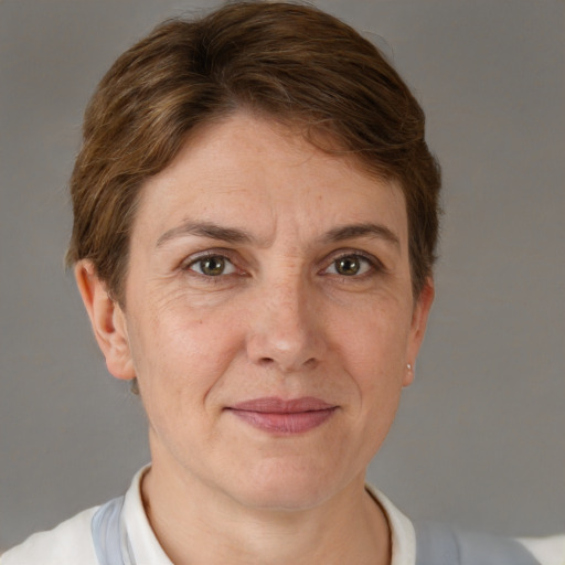 Joyful white adult female with short  brown hair and grey eyes