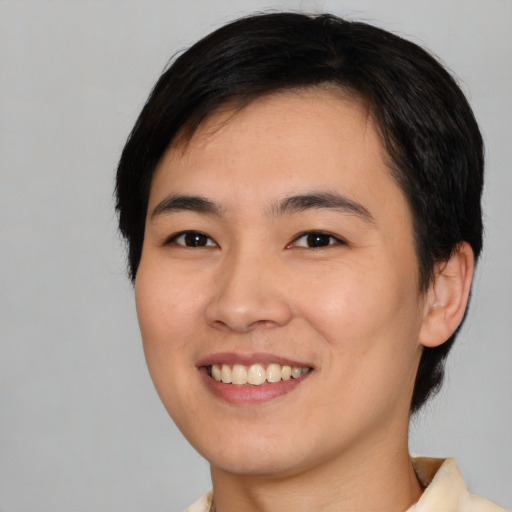 Joyful asian young-adult female with short  black hair and brown eyes