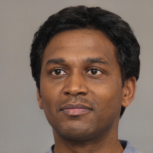 Neutral black young-adult male with short  black hair and brown eyes
