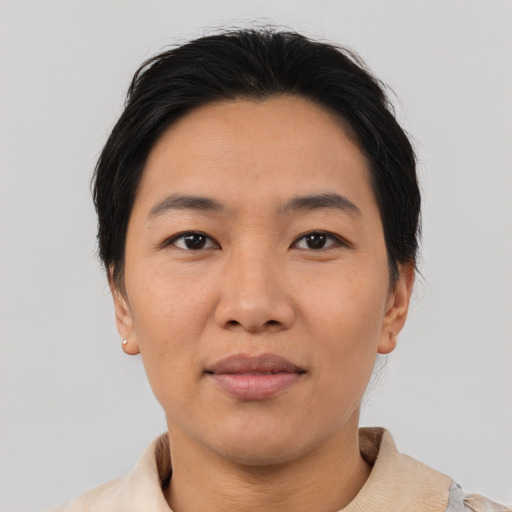 Joyful asian young-adult female with short  black hair and brown eyes