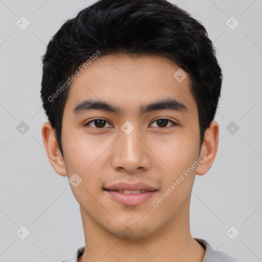 Joyful asian young-adult male with short  black hair and brown eyes