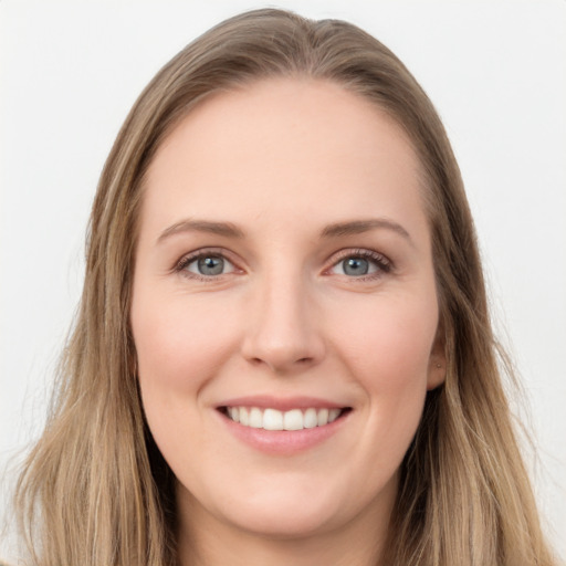 Joyful white young-adult female with long  brown hair and grey eyes