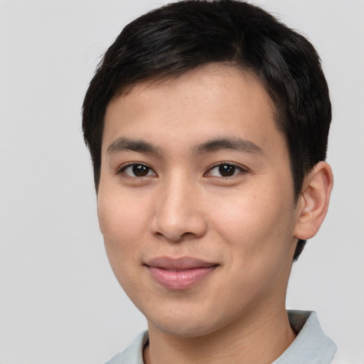 Joyful asian young-adult male with short  black hair and brown eyes